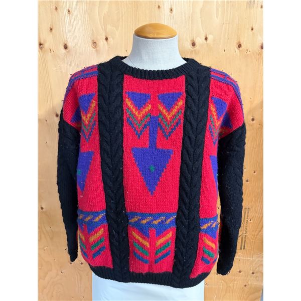 Vintage 1980s or 1990s knit pullover sweater featuring a bold red and black design with geometric an