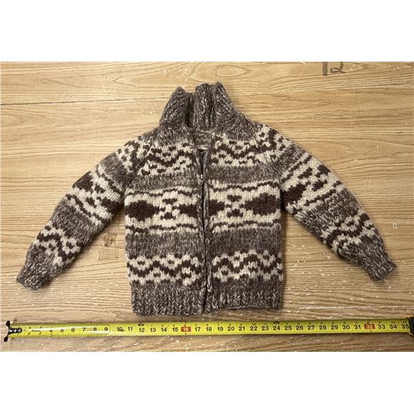 Vintage hand-knit wool full-zip cardigan sweater featuring a classic brown and cream geometric patte