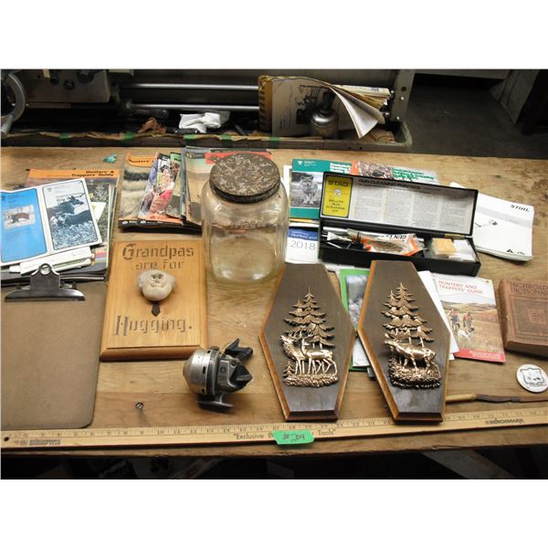 gun cleaning kit, knife, fishing reel, books, etc.