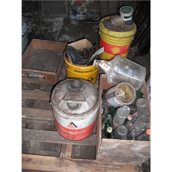pallet of pop bottles, crates, Allis-Chalmers can, etc.