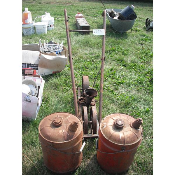 2 metal gas cans and cast iron seeder