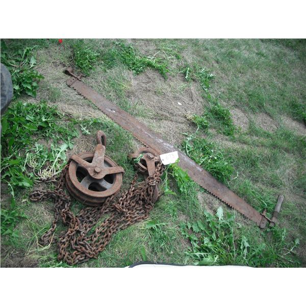 vintage steel pulley and crosscut saw