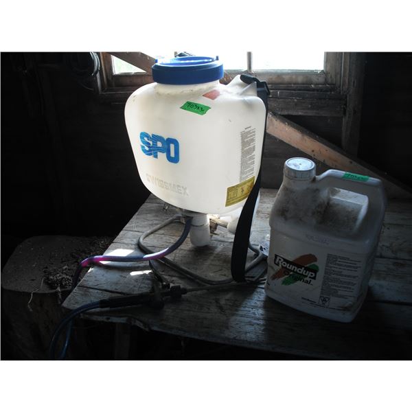 partial jug of roundup and backpack sprayer