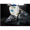 Image 1 : partial jug of roundup and backpack sprayer