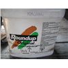 Image 2 : partial jug of roundup and backpack sprayer