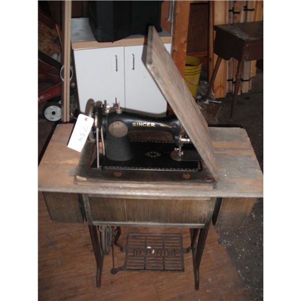 vintage singer sewing machine with cast iron base and accessories