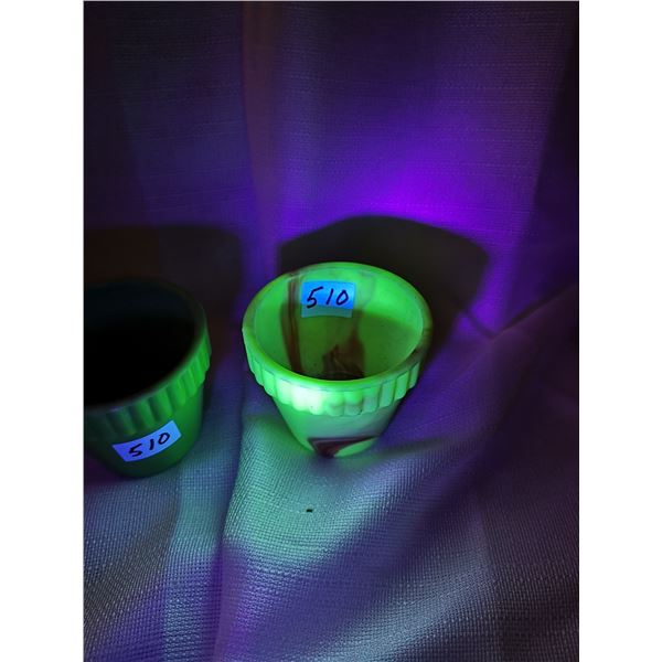 Two antique plant holders, one glows