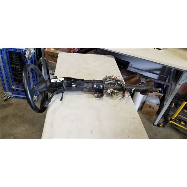 THRE SPOKE STEERING WHEEL ATTACHED TO STEERING COLUMN