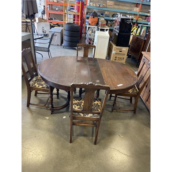 ANTIQUE DINING TABLE ON CASTERS W/ 4 CHAIRS AND LEAF