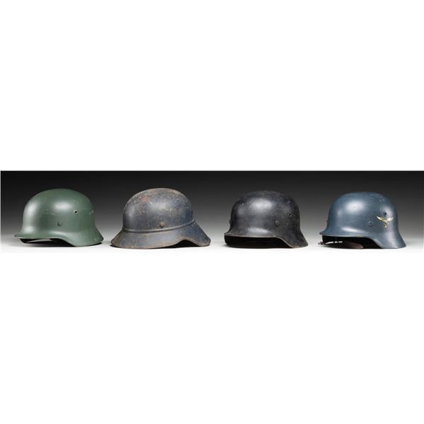 4 WWII GERMAN HELMETS.