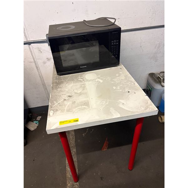 L2 - Panasonic Black Countertop Microwave Oven on White Utility Table with Red Legs
