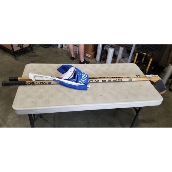 3 HOCKEY STICKS AND 2 CANUCK FLAGS
