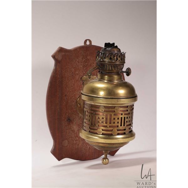 Vintage/ antique brass wall mounted oil lamp marked "English Make", 12" in height, mounted on wooden