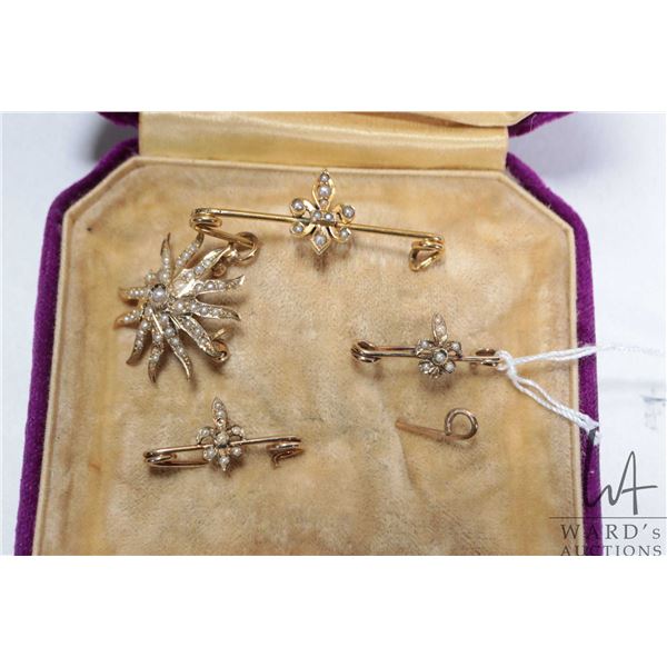 Selection of antique seed pearl jewellery including three fleur-de-lis pines and a sunburst pendant,