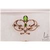 Image 2 : Three antique brooches including tested 14kt yellow gold set with peridot like green gemstones, and 