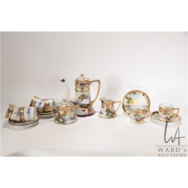 Antique hand-painted Noritake coffee service with scenic landscape panels and heavy gold gilding. In