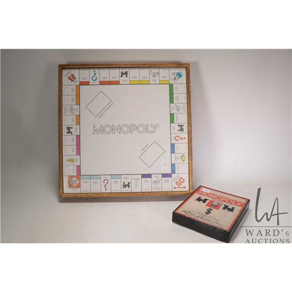 Game box with vintage Monopoly board and checker game on verso with game pieces and dice plus a boxe