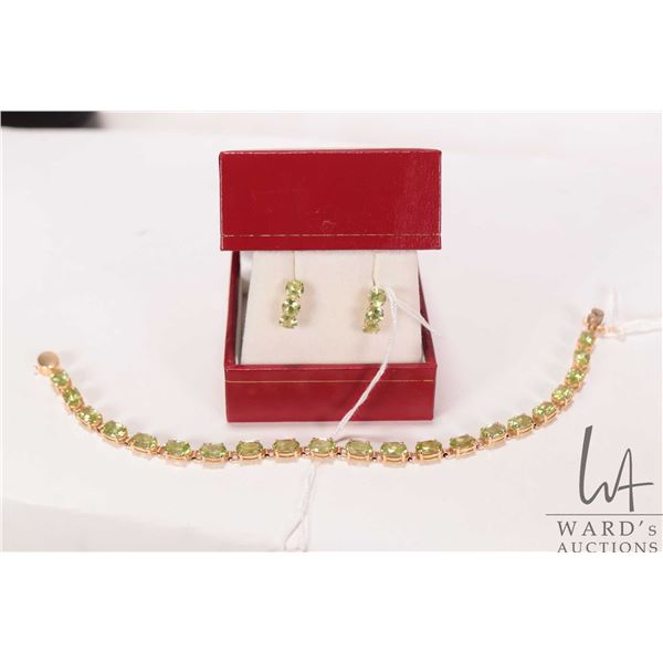 14kt yellow gold and peridot gemstone bracelet, size 7" and a pair of 14kt yellow gold and peridot e
