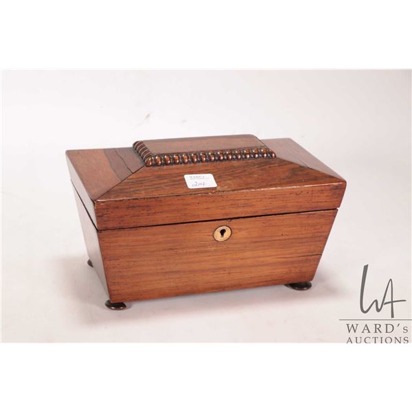 Antique Georgian rosewood sarcophagus tea caddy with brass keyhole escutcheon on small bun feet 5" H