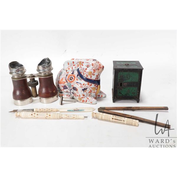 Selection of vintage collectibles including anrique bincoluars, cast metal bank, small razor, foldin