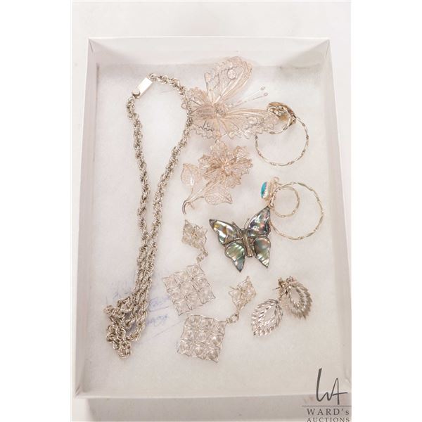 Selection of silver jewellery including filigree brooches, earrings and a Mexican silver chain