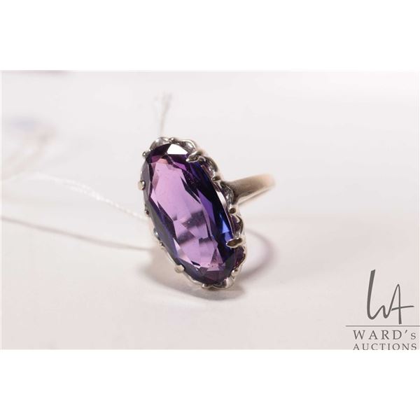 14kt white gold ring set with large oval cut purple sapphire like gemstone, size 5.75
