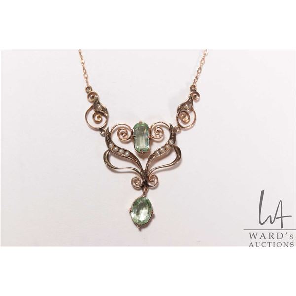 Antique lavaliere set with seed pearls and green peridot like gemstones attached to 10kt yellow gold