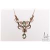 Image 1 : Antique lavaliere set with seed pearls and green peridot like gemstones attached to 10kt yellow gold