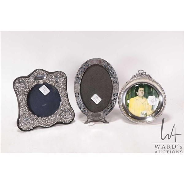 Three sterling silver picture frams including oval Birks sterling pierced frame 7 1/4" X 5", repouss