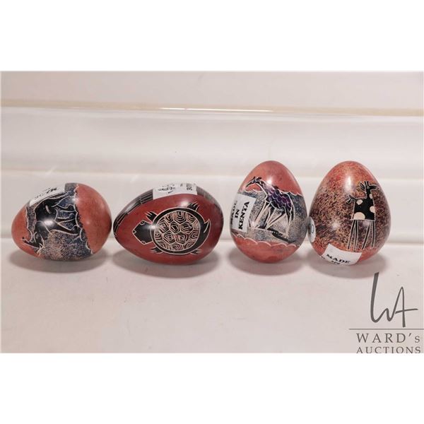 Four African made, hand carved stone eggs