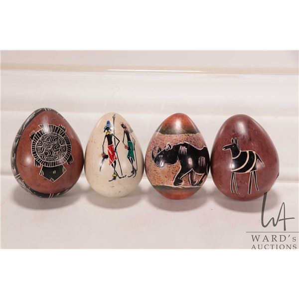 Four African made, hand carved stone eggs