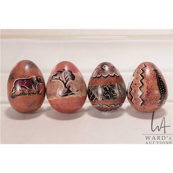 Four African made, hand carved stone eggs