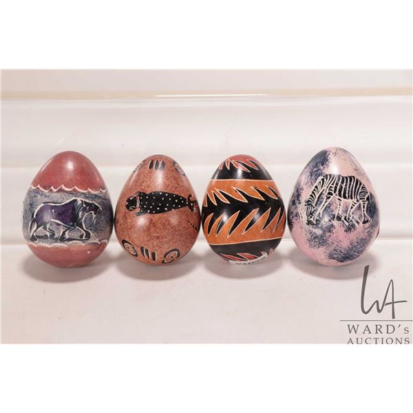 Four African made, hand carved stone eggs