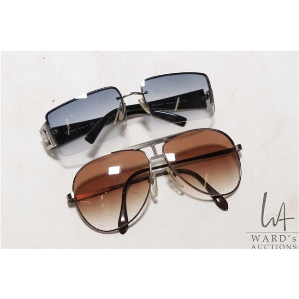 Two pairs of sunglasses including marked Versace and Porsche Note: buyer to satisfy themselves as to