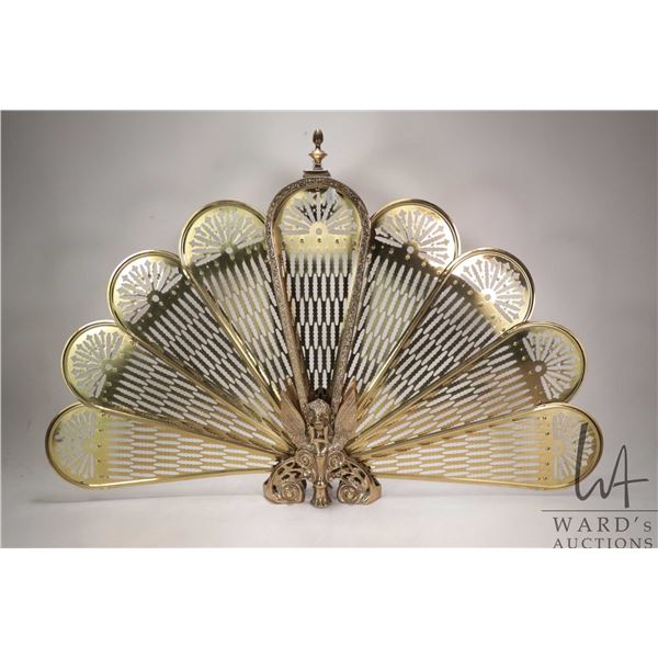 Vintage brass peacock tail folding fireplace screen with winged gargoyle base, measures 38" across a