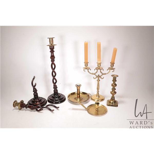 Selection of vintage and antique candlesticks including brass, candelabra, and a carved English dark