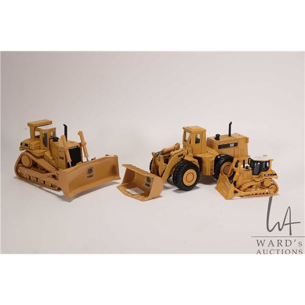 Three Ertl 1:48 scale die cast models including a Caterpiller D-10N, a Caterpillar 988B loader and a