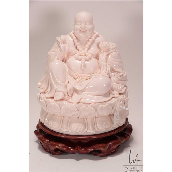 Glazed and bisque Chinese Buddha figure on wooden plinth, 9" in height