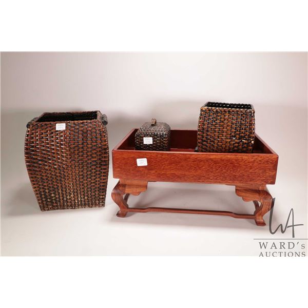 Two Asian woven wicker baskets, a rosewood tray, a rosewood footed stool and a wicker style lidded b