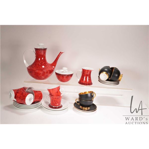 Red and white tea service with teapot, cream, lidded sugar and six demitasse cups and saucers and a 