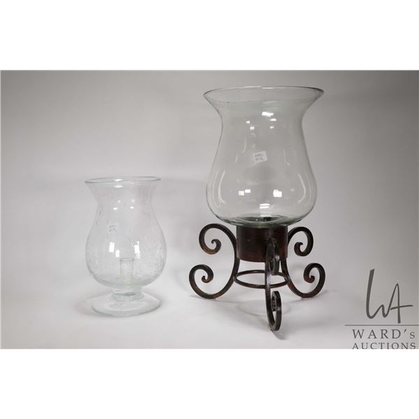 Two large glass hurricane style candle holders including 11" and 18" with metal base