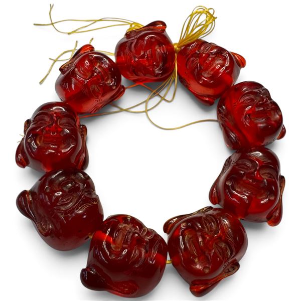 9 Carved Red-Amber Style Resin Buddha Heads on Stretch Cord (Each head is 30mm x 33mm)