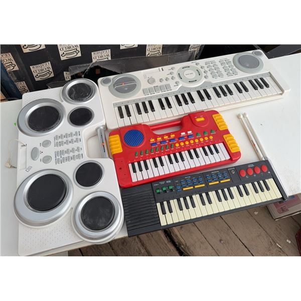 Three Electronic Keyboards and One Drum Machine
