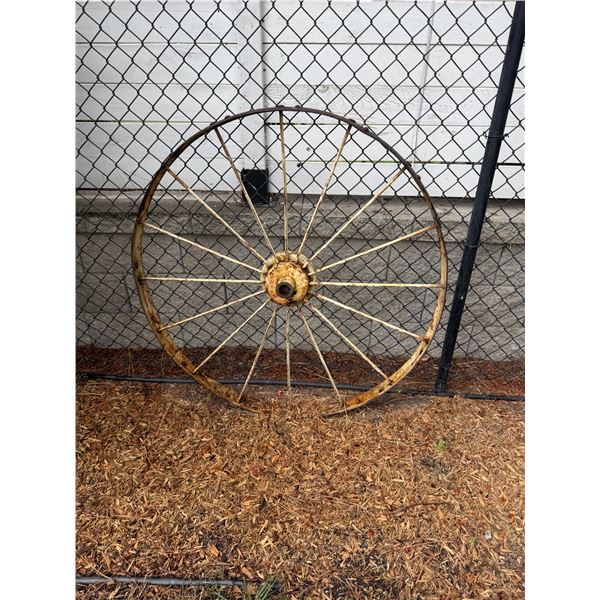 Metal wagon wheel approximately 4 feet tall