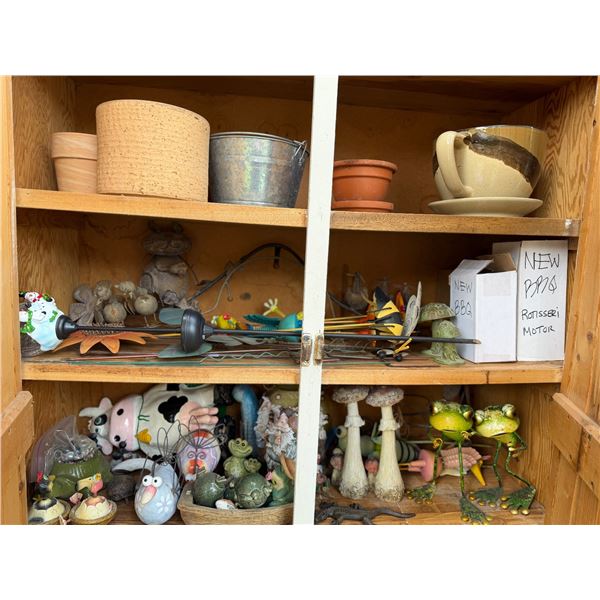 Three shelves of garden decor, and planters