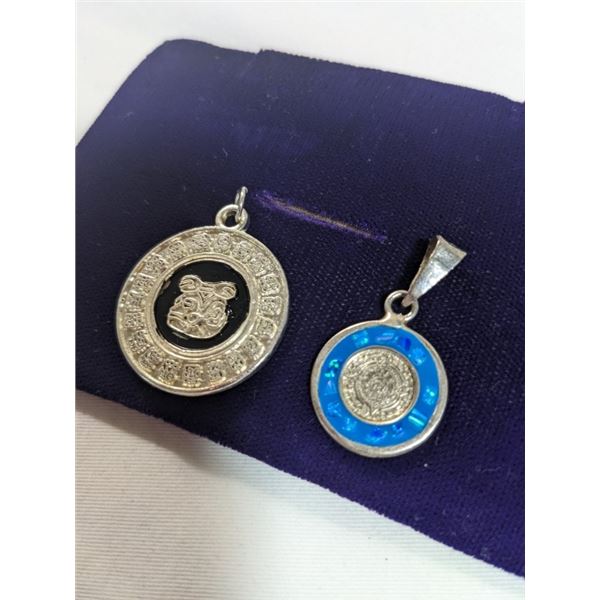 2 MEXICAN SILVER AZTEC CALENDAR PENDANTS ONE INLAID MEXICAN OPAL STONES