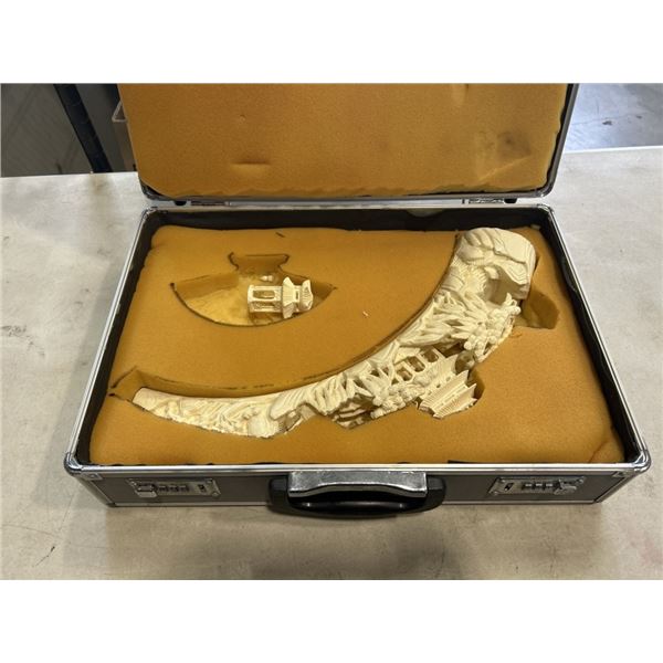 CASED AND HIGHLY CARVED EASTERN TUSK, SOME TYPE OF PLASTIC