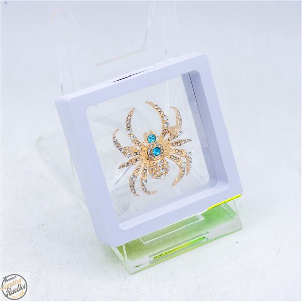 NEW SPIDER BROOCH, GP SPARKING BLUE STONES