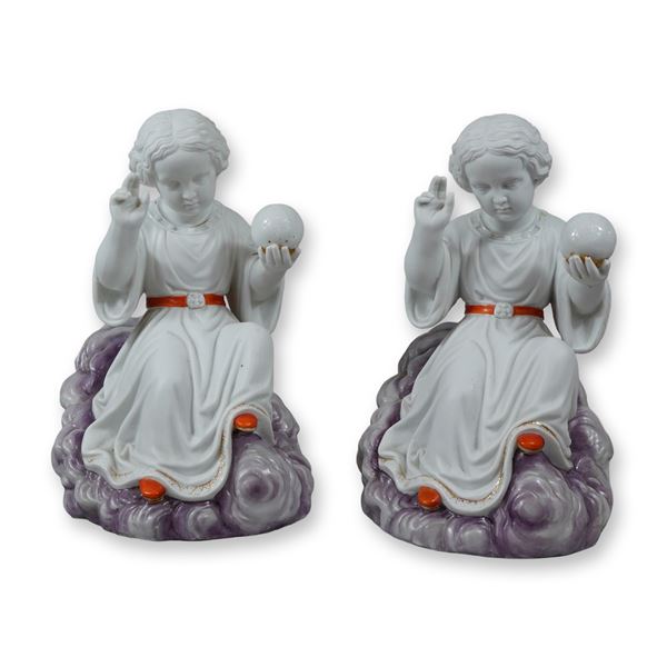 A Pair of Porcelain Figurines Depicting the Child Jesus as Salvator Mundi