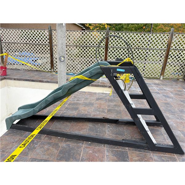 Green plastic playground slide mounted on a black Frame